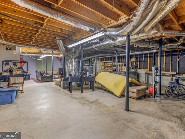 unfinished basement featuring gas water heater