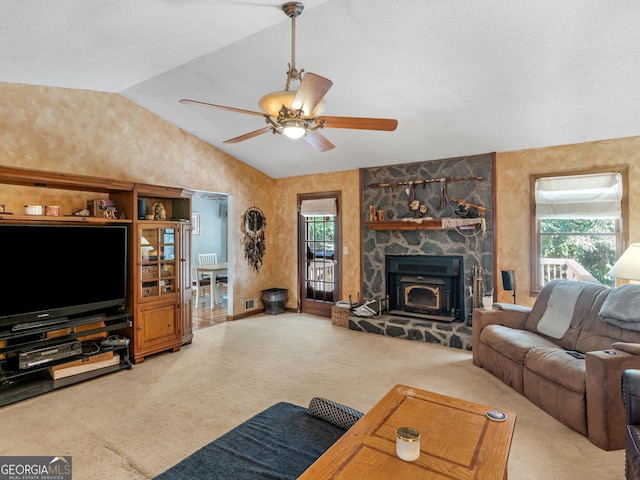 living room with vaulted ceiling, carpet floors, a fireplace, and a ceiling fan