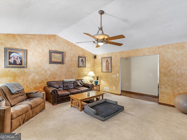 living room featuring carpet floors, ceiling fan, visible vents, and vaulted ceiling