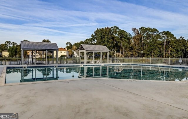 community pool featuring a gazebo, a patio, and fence