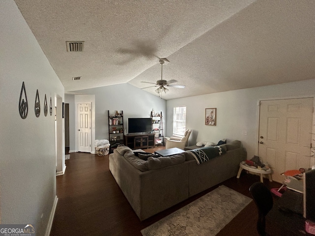 living room featuring lofted ceiling, dark wood-style floors, visible vents, and a ceiling fan