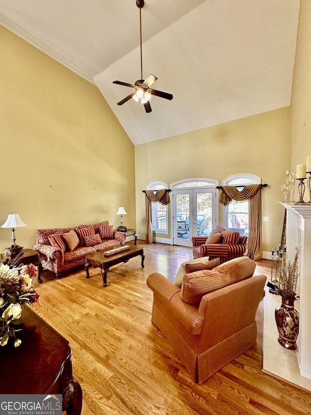 3585 Shepherds Ln, Loganville, GA 30052 - living room featuring baseboards, ceiling fan, wood finished floors, french doors, and high vaulted ceiling