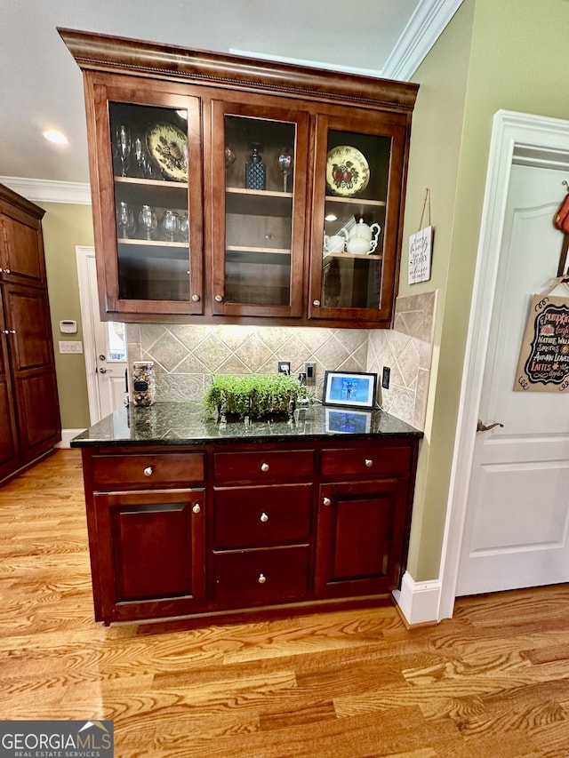 3585 Shepherds Ln, Loganville, GA 30052 - bar featuring light wood-type flooring, tasteful backsplash, and ornamental molding