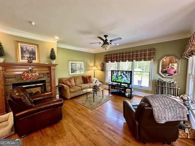 3585 Shepherds Ln, Loganville, GA 30052 - living area featuring a fireplace, wood finished floors, a ceiling fan, baseboards, and ornamental molding