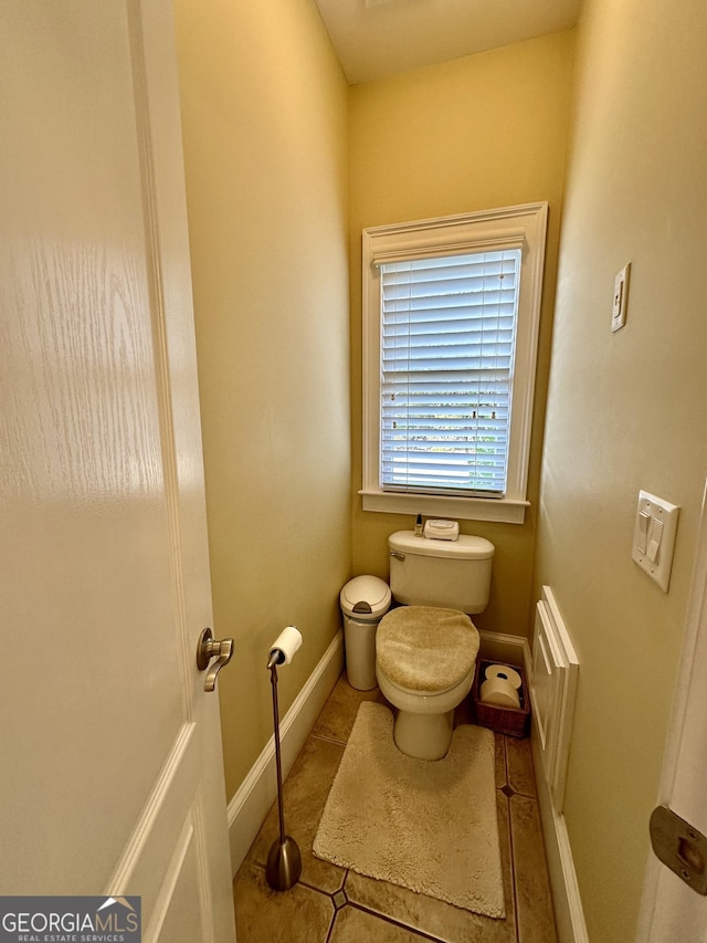 3585 Shepherds Ln, Loganville, GA 30052 - half bathroom featuring toilet, baseboards, and tile patterned floors
