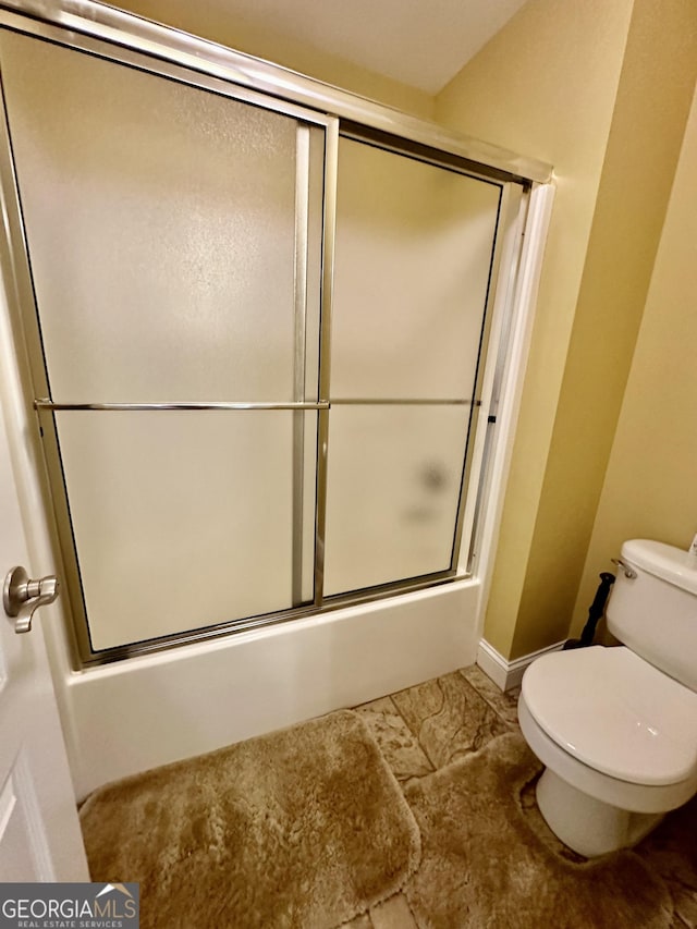 3585 Shepherds Ln, Loganville, GA 30052 - full bathroom featuring combined bath / shower with glass door and toilet