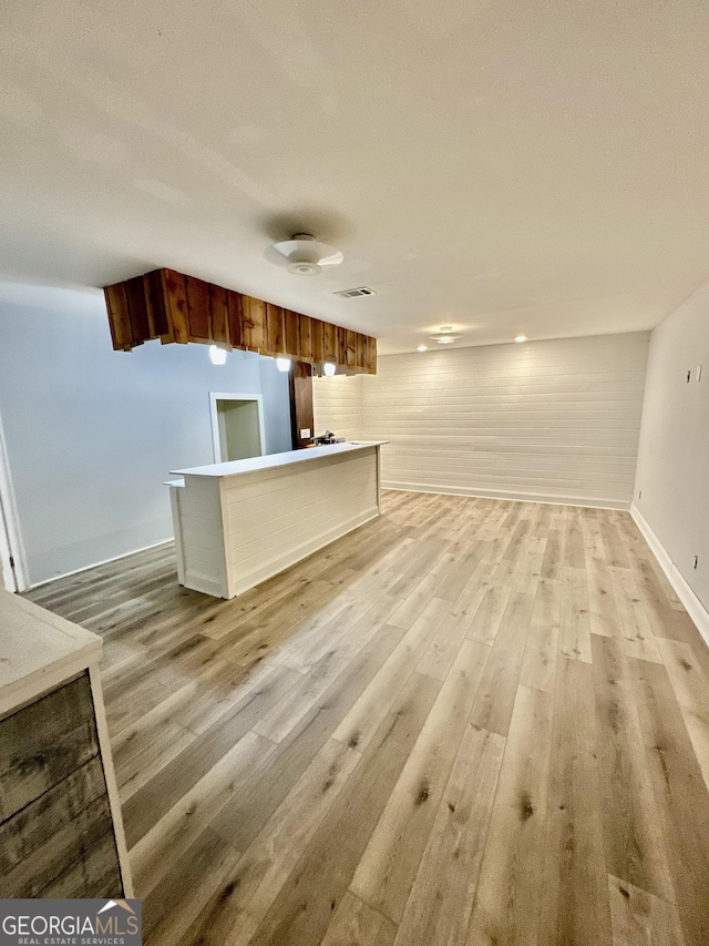3585 Shepherds Ln, Loganville, GA 30052 - unfurnished living room with baseboards, visible vents, and light wood-style floors