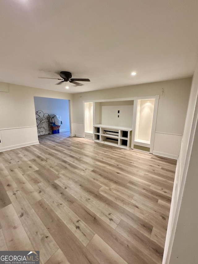 3585 Shepherds Ln, Loganville, GA 30052 - unfurnished living room with a wainscoted wall, light wood-style flooring, and ceiling fan