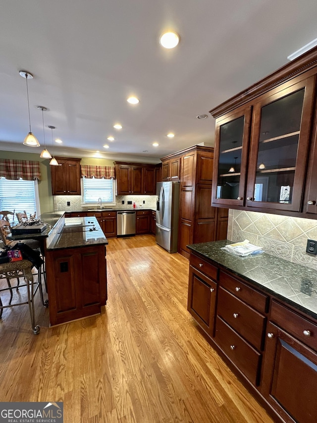 3585 Shepherds Ln, Loganville, GA 30052 - kitchen featuring a sink, hanging light fixtures, appliances with stainless steel finishes, light wood finished floors, and tasteful backsplash