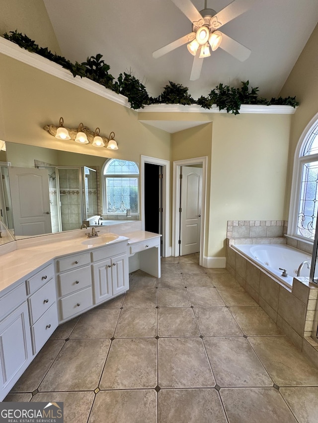 3585 Shepherds Ln, Loganville, GA 30052 - full bath with vaulted ceiling, a garden tub, vanity, and tile patterned floors