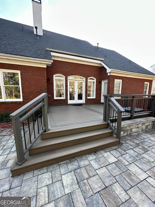 3585 Shepherds Ln, Loganville, GA 30052 - back of property featuring a shingled roof, french doors, brick siding, and a chimney
