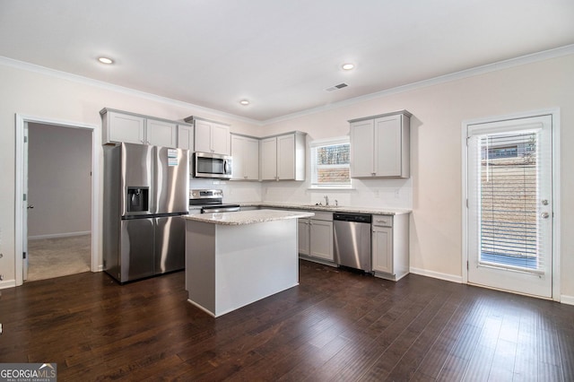 kitchen featuring gray cabinets, visible vents, stainless steel appliances, and dark wood-type flooring