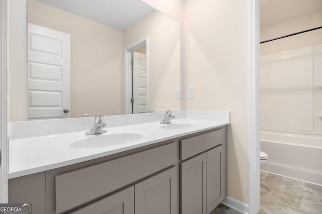 bathroom with shower / washtub combination, a sink, toilet, and double vanity