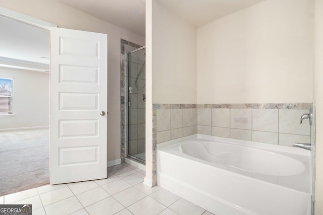 full bath featuring a stall shower, tile patterned flooring, baseboards, and a bath