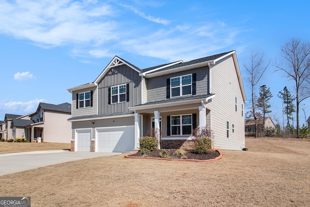 craftsman-style home with a garage, driveway, brick siding, and board and batten siding