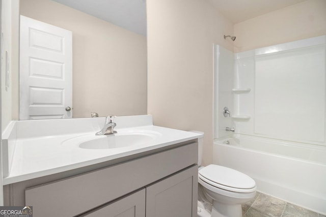 full bathroom featuring washtub / shower combination, vanity, and toilet