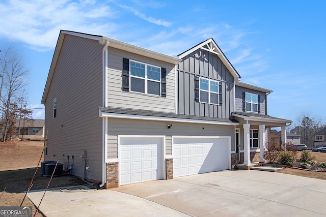 craftsman house with concrete driveway, central AC unit, board and batten siding, and an attached garage