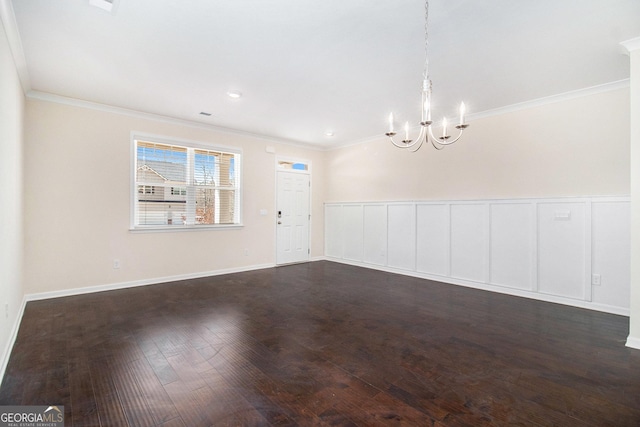 interior space with baseboards, a chandelier, dark wood-type flooring, and crown molding