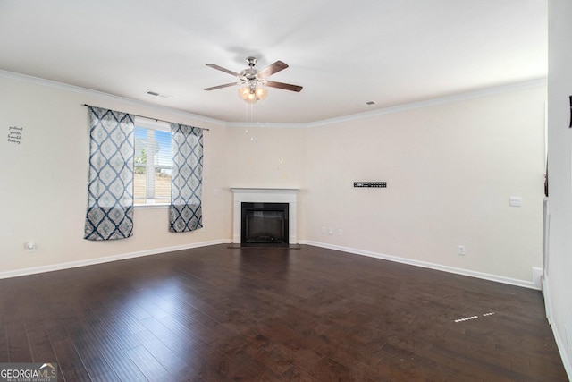 unfurnished living room featuring dark wood-style floors, a glass covered fireplace, visible vents, and crown molding