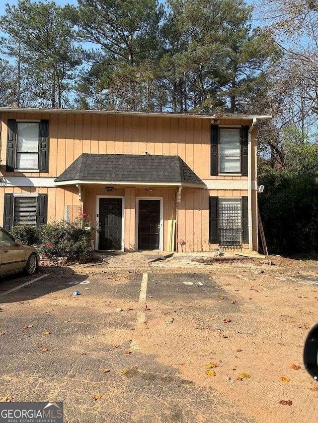 view of front of house with a shingled roof and board and batten siding