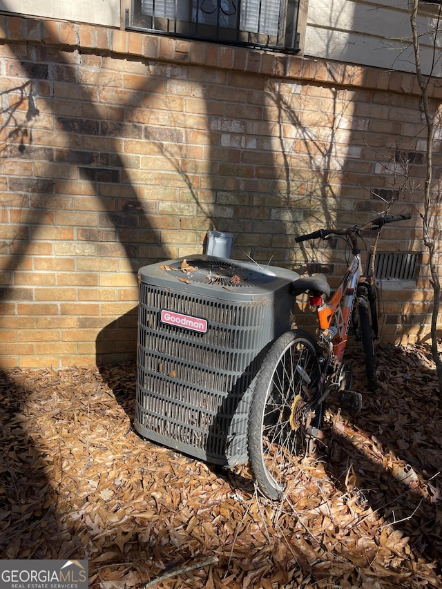 details with central air condition unit and brick siding