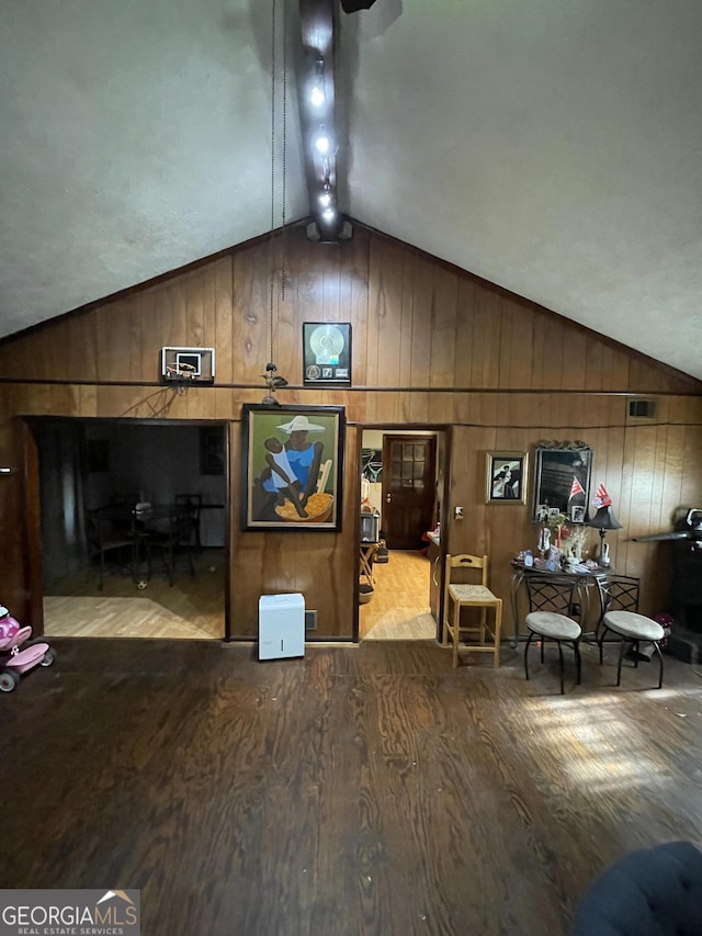 interior space featuring wooden walls, visible vents, and wood finished floors