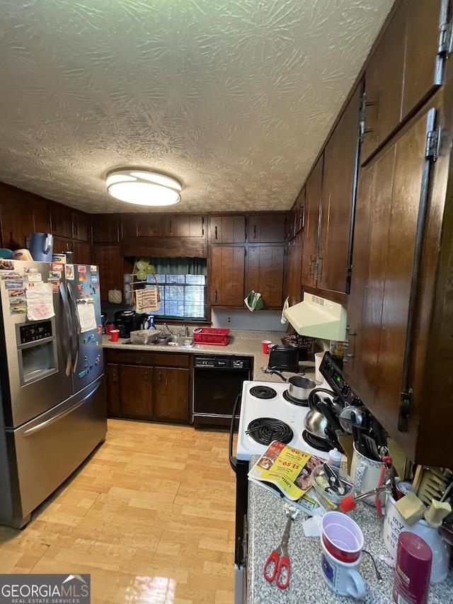 kitchen featuring stainless steel fridge, dishwasher, light wood-style flooring, light countertops, and exhaust hood