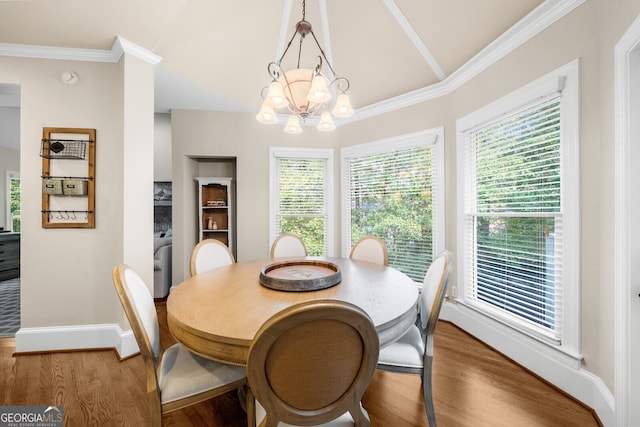 dining area with a notable chandelier, wood finished floors, and a healthy amount of sunlight