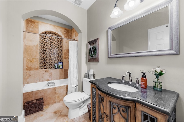 bathroom featuring visible vents, toilet, tiled shower / bath combo, vanity, and tile patterned flooring