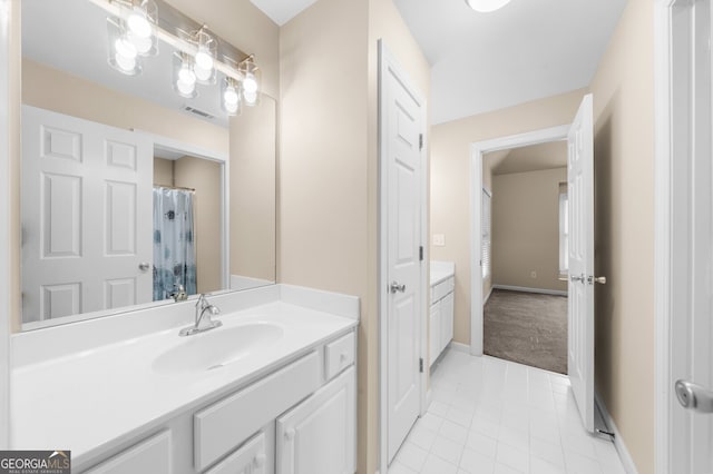 full bath with visible vents, tile patterned flooring, vanity, and baseboards