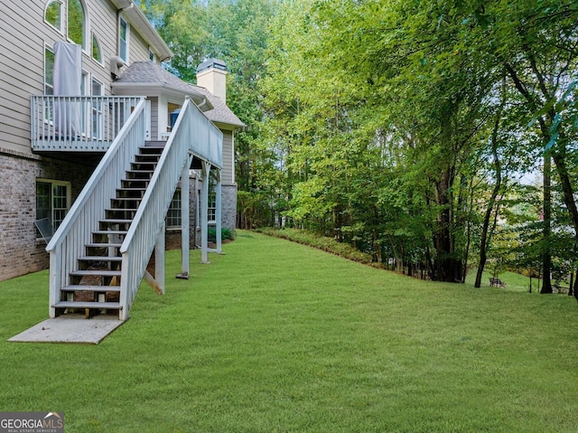 view of yard featuring a deck and stairway