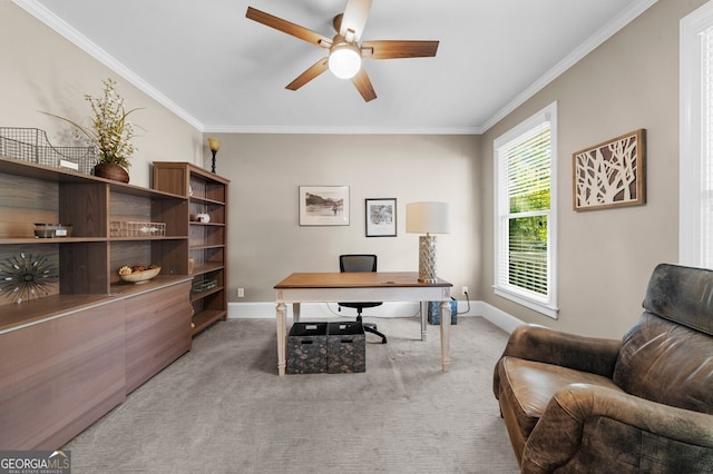 office area with baseboards, crown molding, and light colored carpet