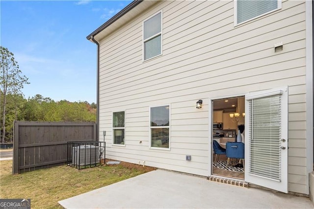 rear view of house featuring a yard, a patio area, and fence