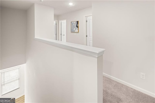 corridor with light carpet, baseboards, and recessed lighting