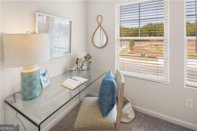 carpeted office featuring baseboards