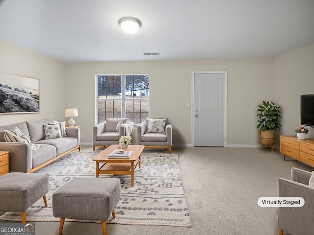 carpeted living area with baseboards and visible vents