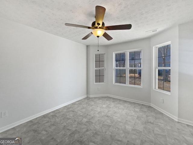 11403 S Grove Dr, Hampton, GA 30228 - unfurnished room featuring ceiling fan, a textured ceiling, and tile patterned floors