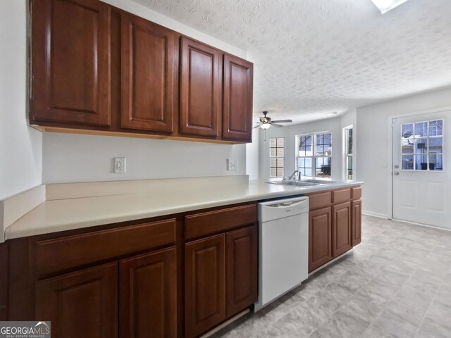 11403 S Grove Dr, Hampton, GA 30228 - kitchen featuring dishwasher, a textured ceiling, light countertops, ceiling fan, and a peninsula