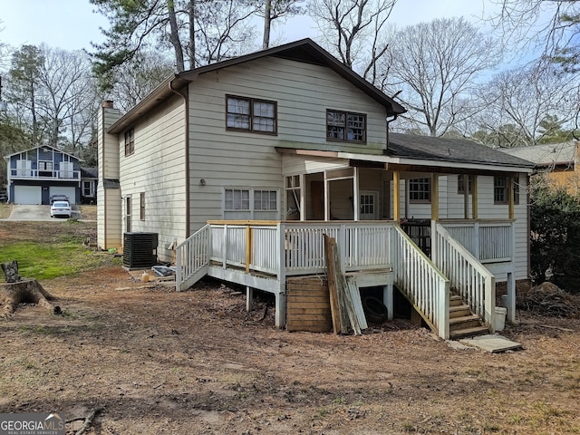 rear view of property with a chimney, stairway, central AC, and a wooden deck