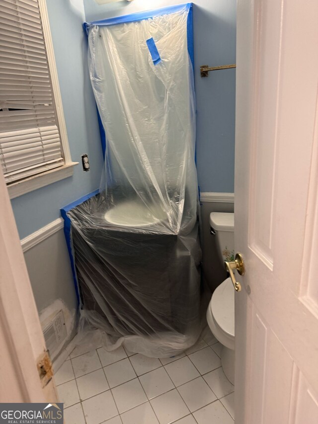 bathroom with visible vents, tile patterned flooring, and toilet