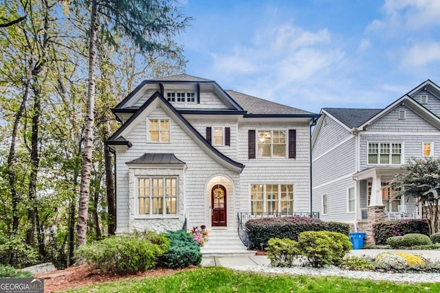 shingle-style home featuring a shingled roof