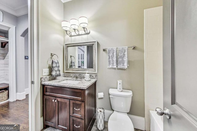 full bathroom with toilet, wood finished floors, vanity, baseboards, and ornamental molding