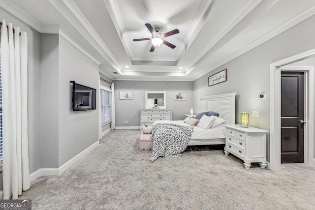 bedroom with baseboards, a raised ceiling, crown molding, and light colored carpet