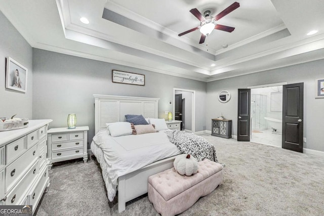 carpeted bedroom with baseboards, a tray ceiling, and ornamental molding