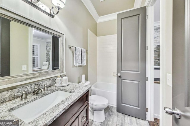 bathroom with toilet, ornamental molding, wood finish floors, and vanity