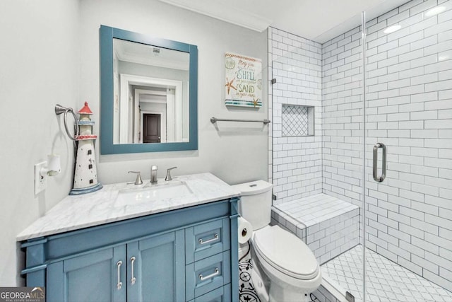 full bathroom featuring a shower stall, toilet, and vanity