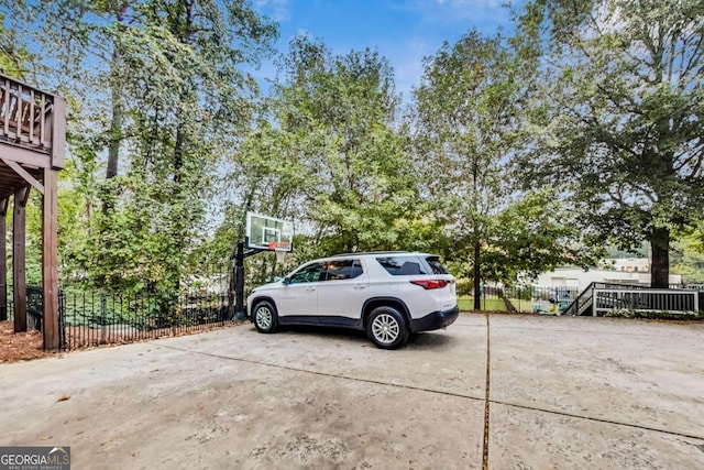 view of parking with fence