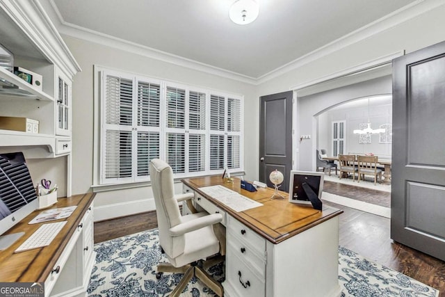 office featuring dark wood-style floors, a chandelier, arched walkways, and crown molding