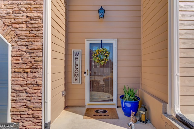 property entrance featuring stone siding