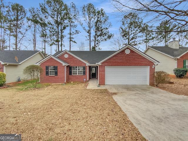 single story home featuring an attached garage, concrete driveway, and brick siding